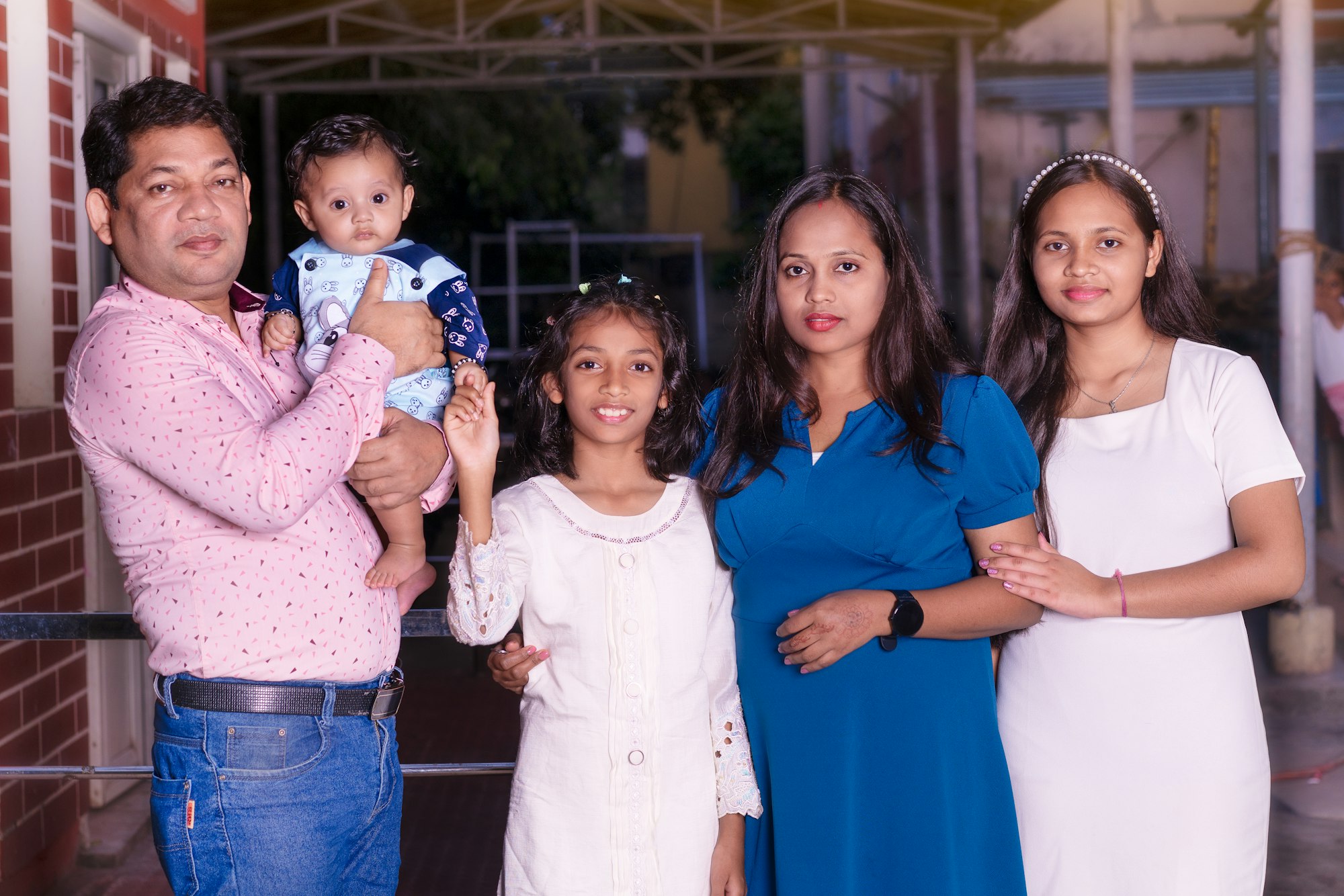 An Indian family of five with two children and a baby
