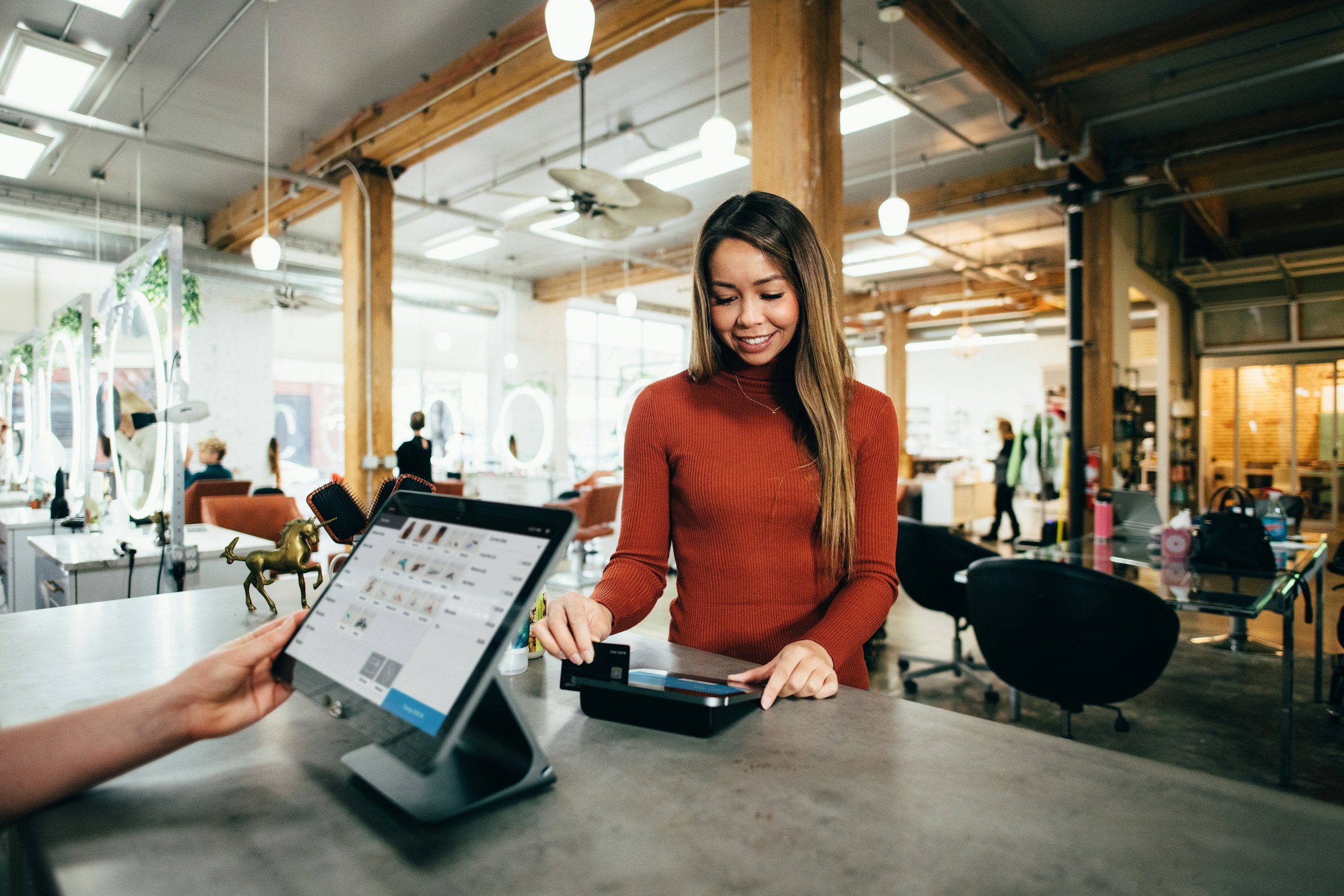 A smiling team member at work in a bright, modern space